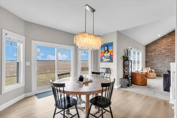 a room with white cabinets and wooden floor