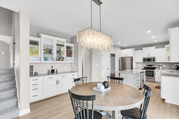 a bathroom with a granite countertop toilet sink and mirror