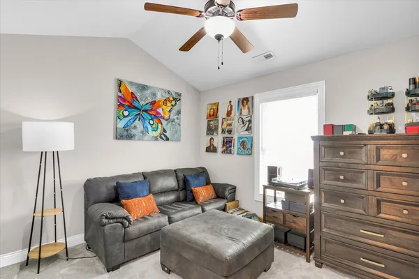 a spacious bedroom with a bed and a flat screen tv