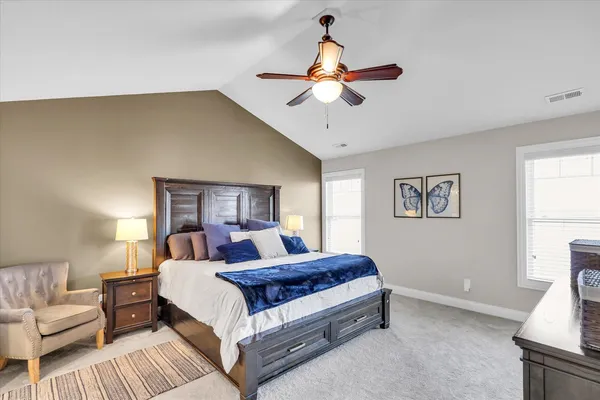 a bedroom with a bed and a television