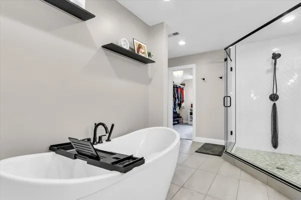 a bedroom with a bed lamp and a window