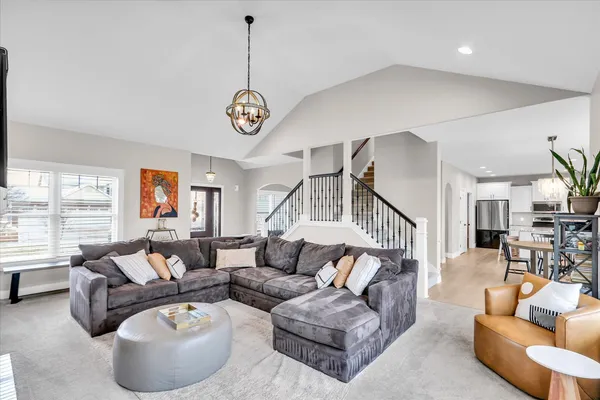 a living room with furniture ceiling fan and a large window