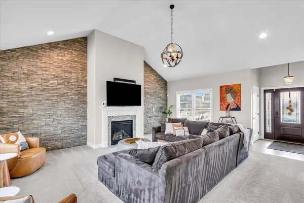 a living room with furniture fireplace and flat screen tv