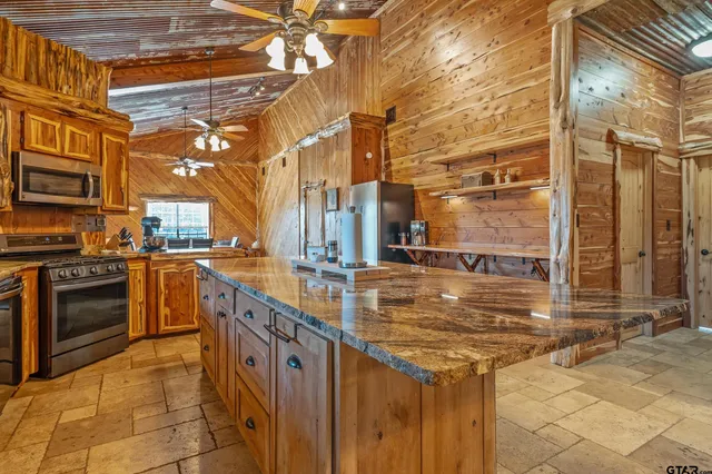 a kitchen that has a sink and a stove in it