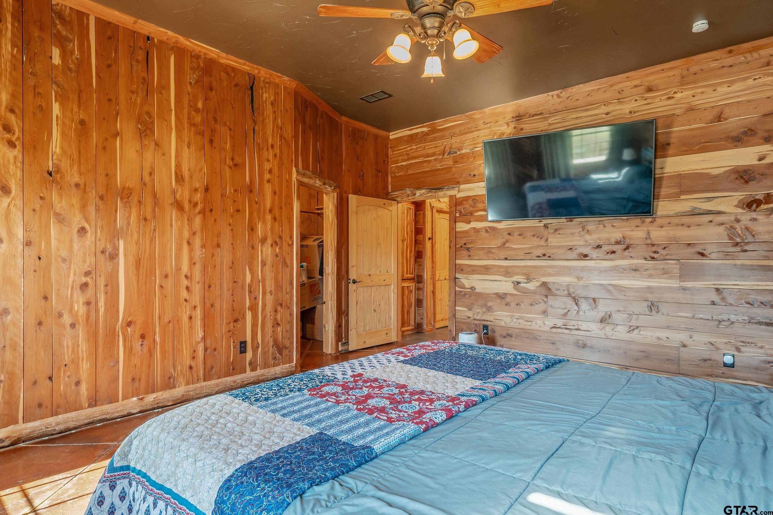 2600 Van Meter Road Kilgore, TX 75662 - Photo 20 of 48 a bedroom with a bed and a flat screen tv