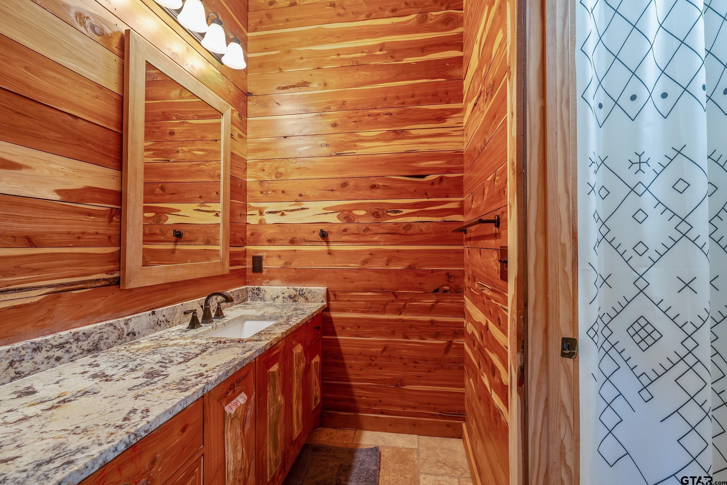 2600 Van Meter Road Kilgore, TX 75662 - Photo 31 of 48 a bathroom with a granite countertop sink a mirror and a shower