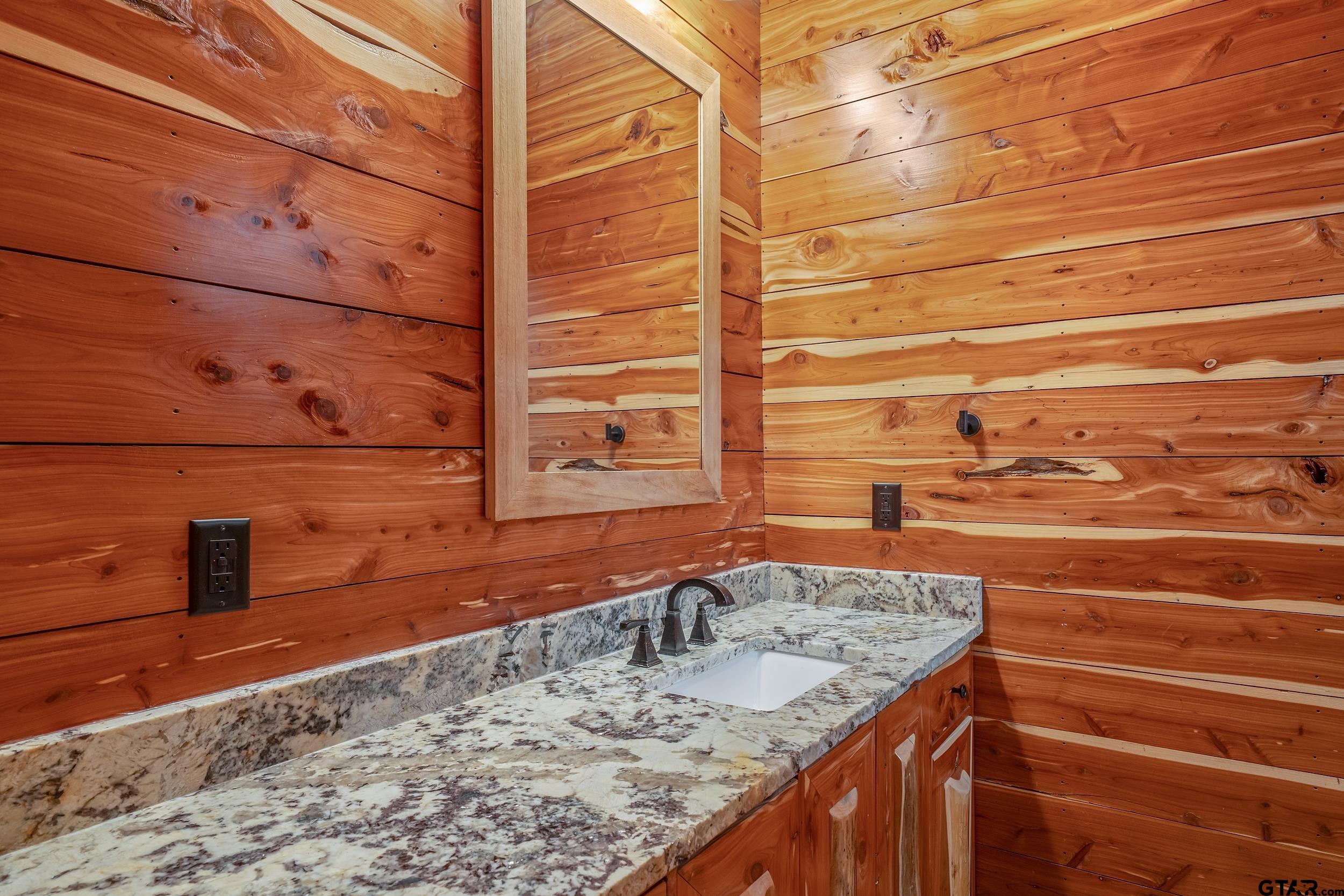 2600 Van Meter Road Kilgore, TX 75662 - Photo 33 of 48 a bathroom with a granite countertop sink and a mirror