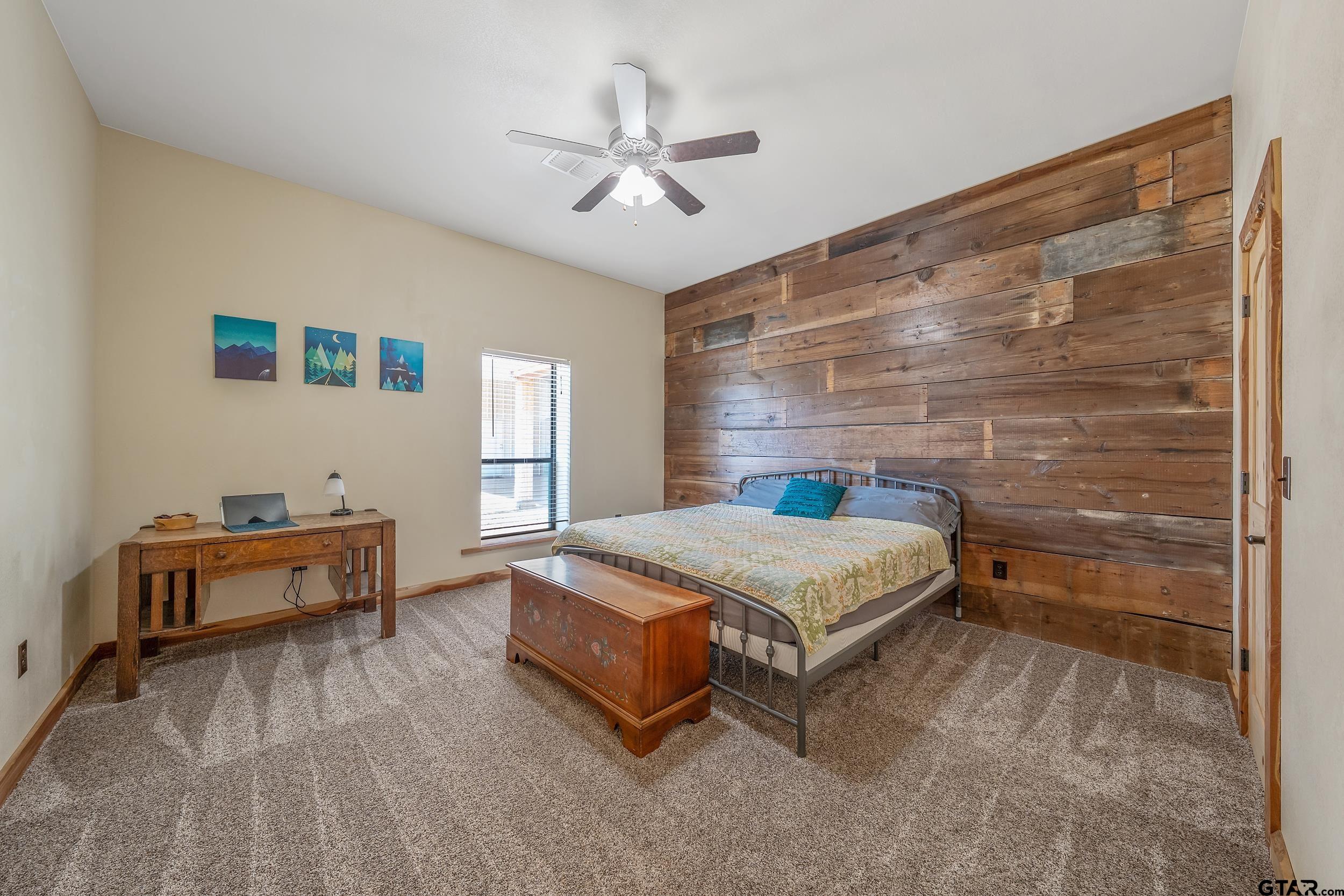 2600 Van Meter Road Kilgore, TX 75662 - Photo 34 of 48 a bedroom with a bed and a chandelier