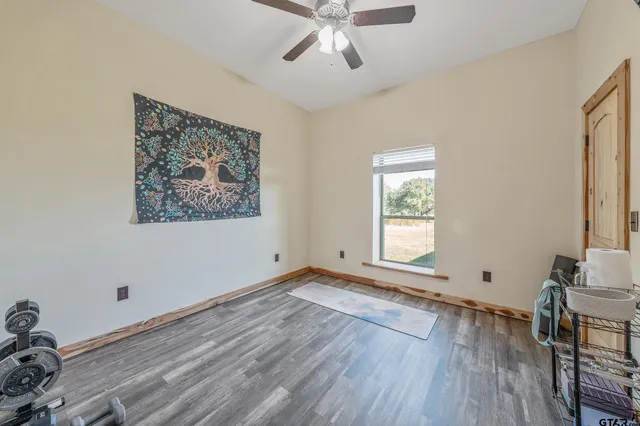 a view of a livingroom with wooden floor and a flat screen tv