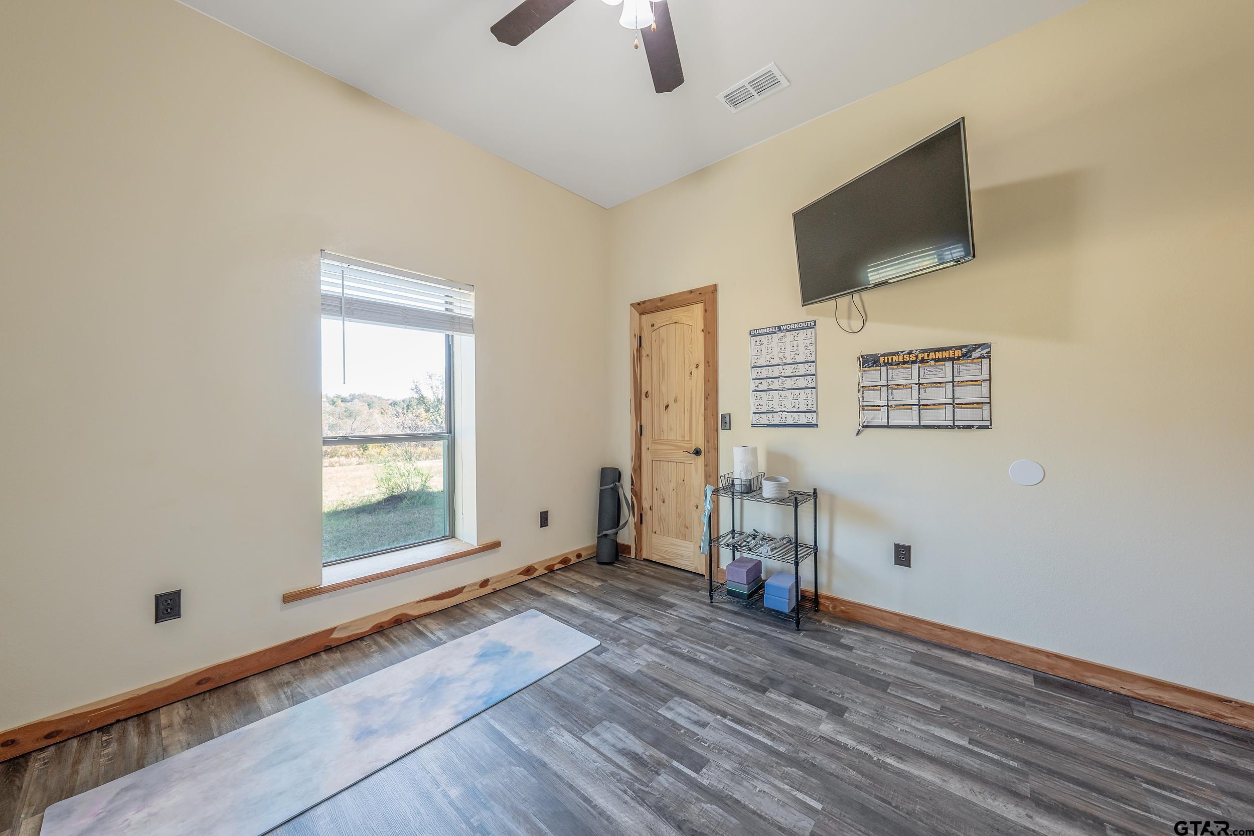 2600 Van Meter Road Kilgore, TX 75662 - Photo 37 of 48 a view of a livingroom with wooden floor and a flat screen tv
