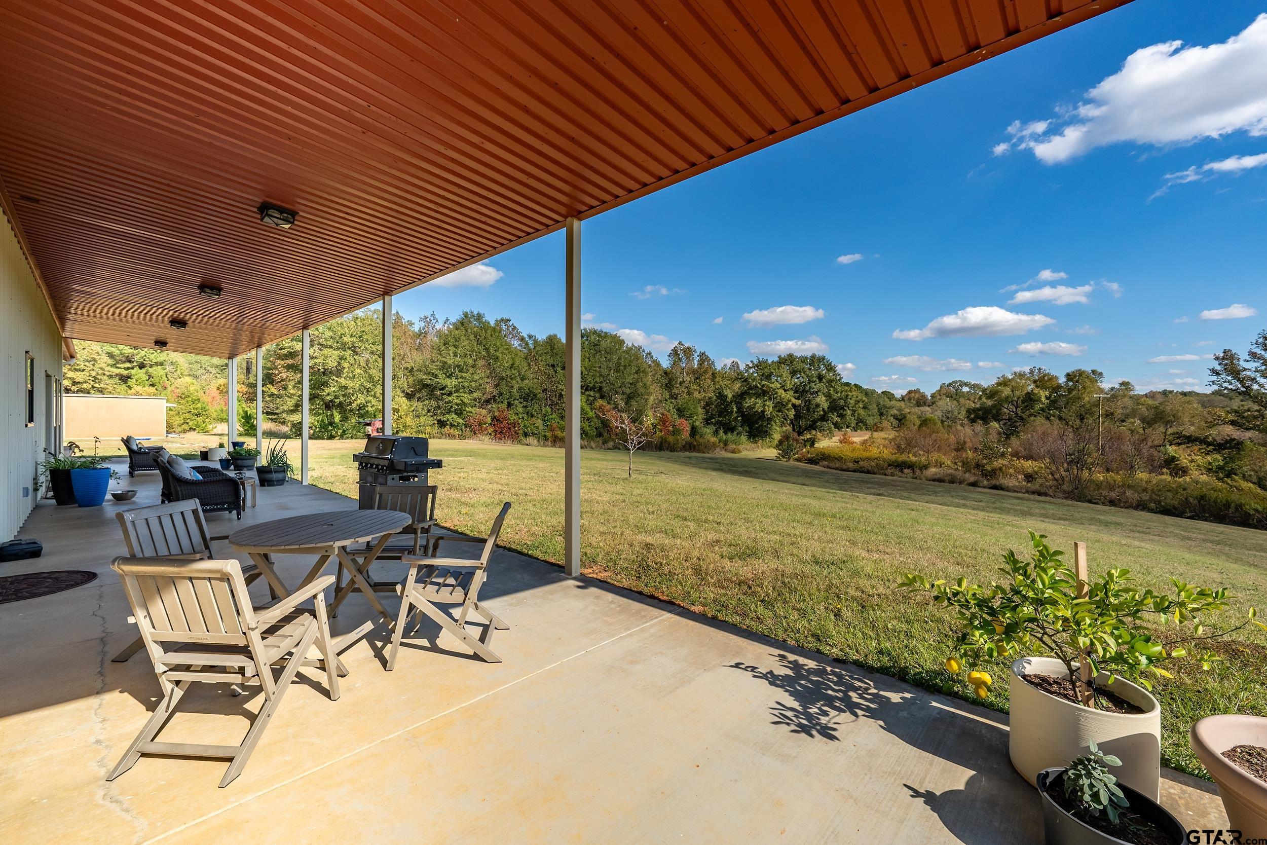 2600 Van Meter Road Kilgore, TX 75662 - Photo 44 of 48 a view of a patio with a table chairs and ocean view