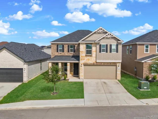 a front view of a house with a garden and plants