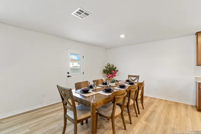 a view of a dining room with furniture and wooden floor