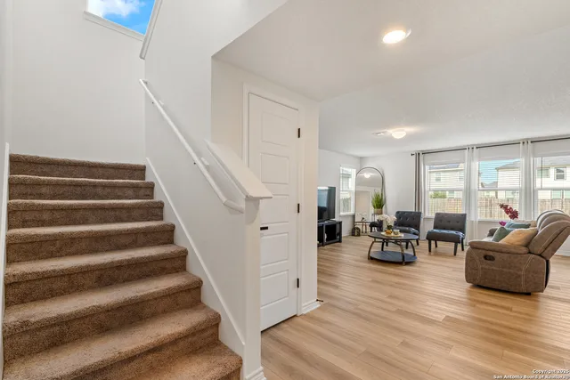 a living room with furniture and a view of dining room