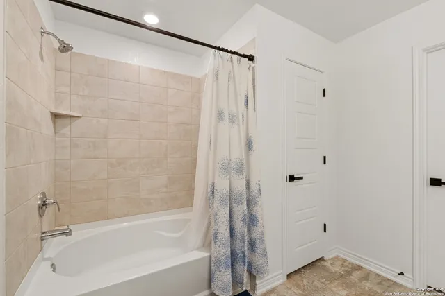 a bathroom with a bathtub and a shower