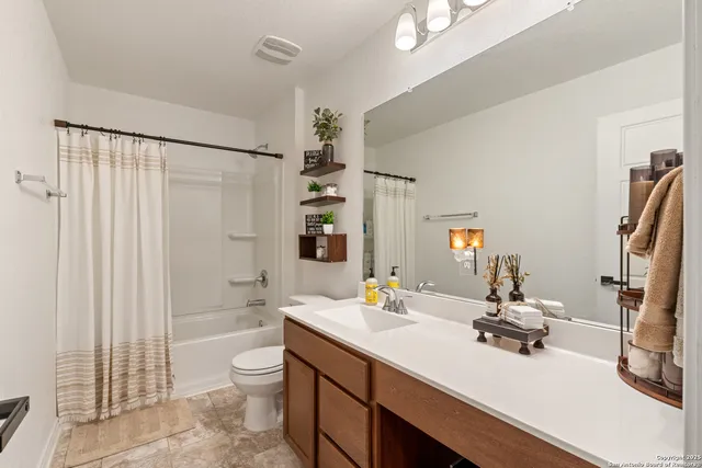 a bathroom with a double vanity sink toilet and shower