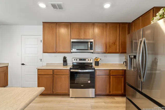 a kitchen with sink a microwave and refrigerator
