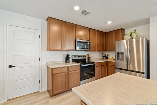 a kitchen with a refrigerator stove and sink