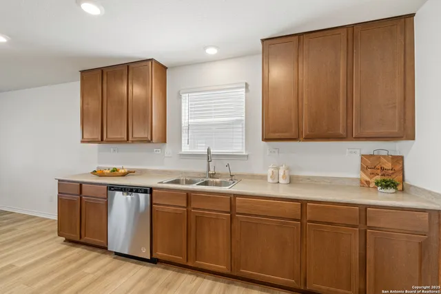 a kitchen with sink cabinets and wooden floor
