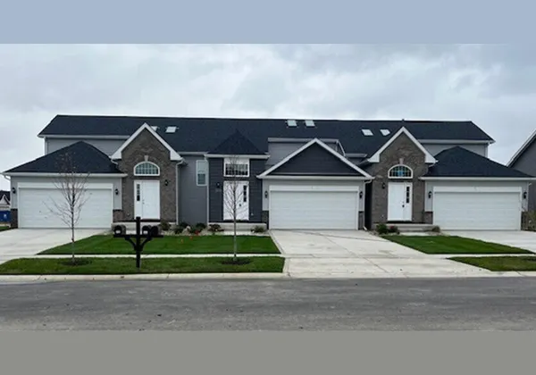 a front view of a house with a yard