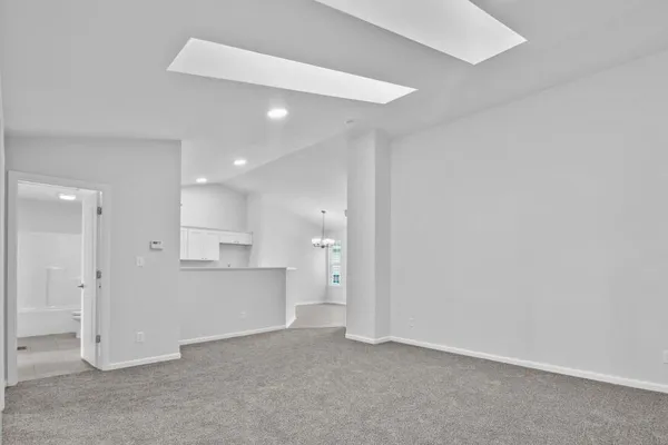 a view of a kitchen with refrigerator and a sink