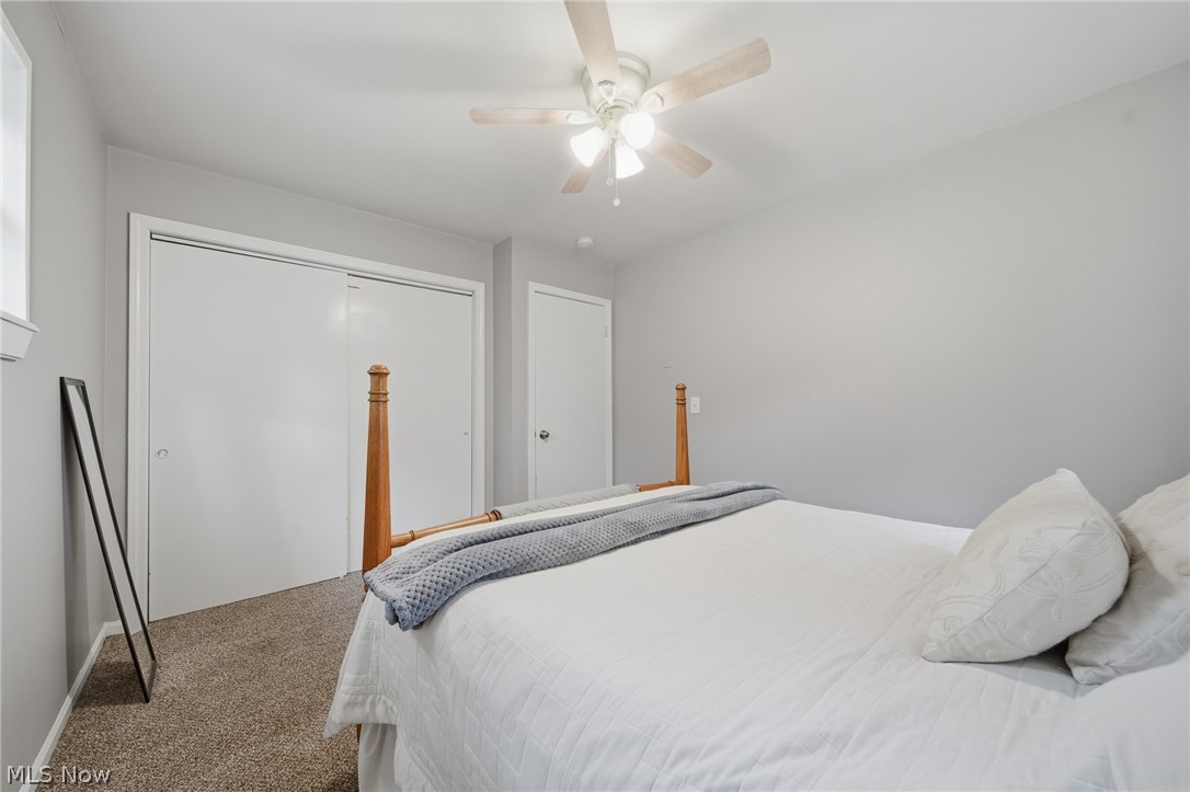 3471 State Rte 5 Newton Falls, OH 44444 - Photo 14 of 31 Room featuring light gray walls, textured carpet flooring, and a ceiling fan with integrated lighting
