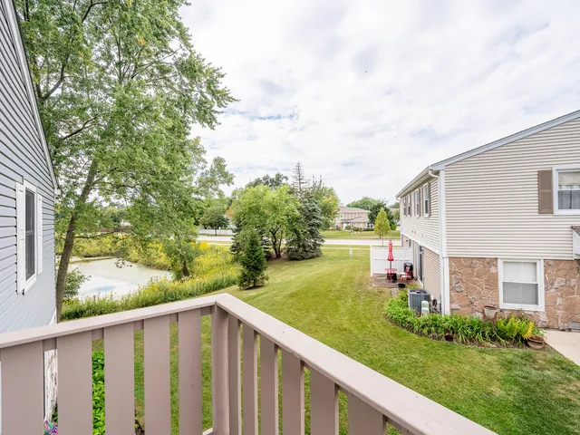 a balcony with wooden floor and fence