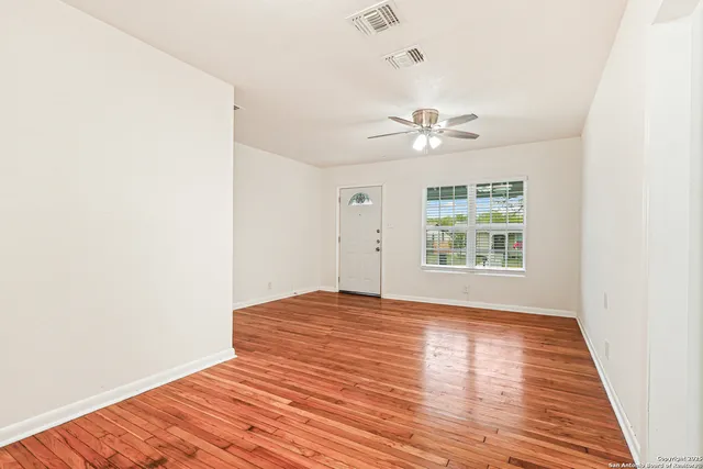 wooden floor in a room next to a window