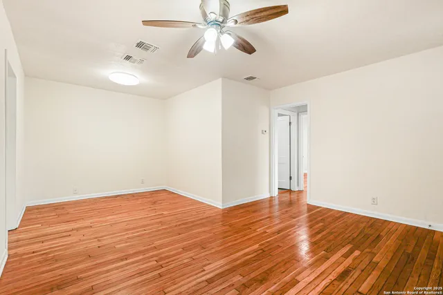 a view of an empty room and wooden floor
