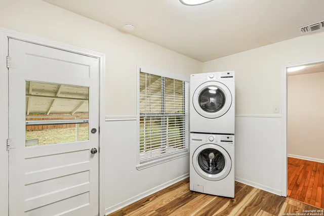 a view of a storage and utility room with washer and dryer