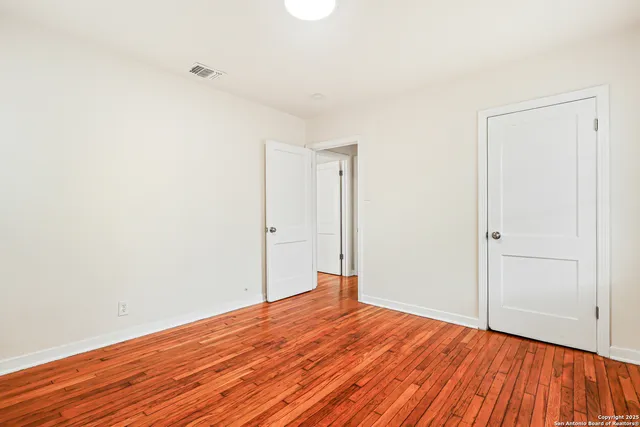 a view of a room with wooden floor