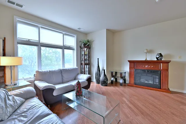 a living room with furniture and a fireplace
