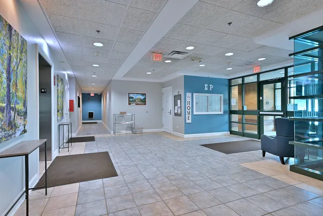 a lobby with a rug and a rug