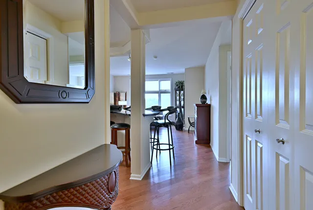 a view of a hallway with furniture and wooden floor