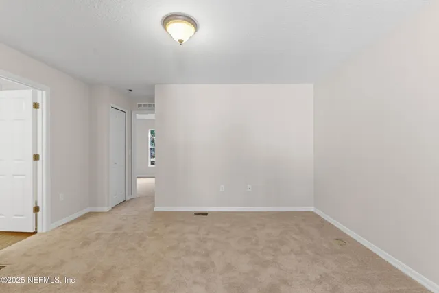 a view of a house with backyard and a tree