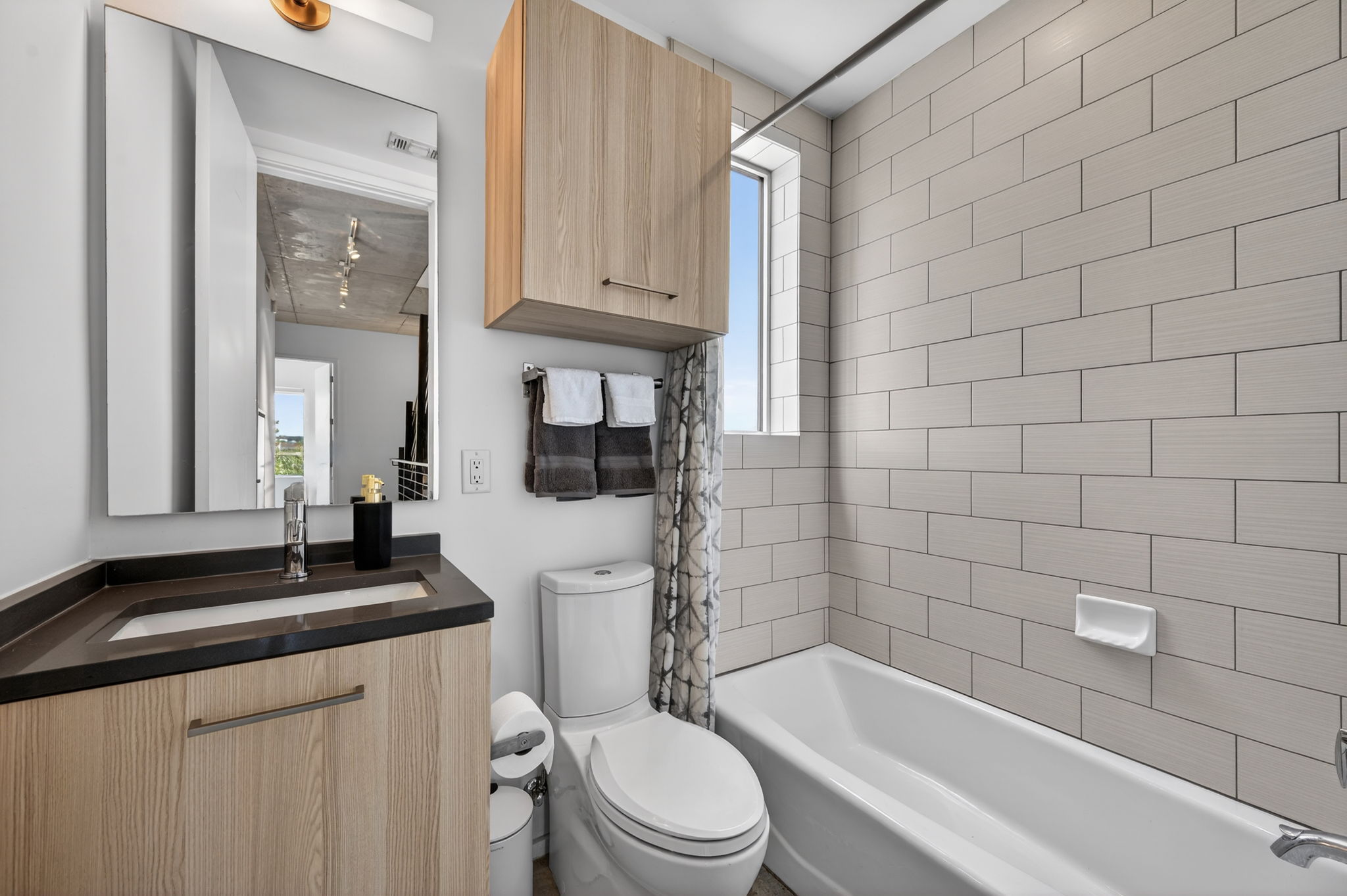 2301 South 5th Street, Unit 25 Austin, TX 78704 - Photo 22 of 35 Full bathroom with shower / bath combo with shower curtain, vanity, and healthy amount of natural light