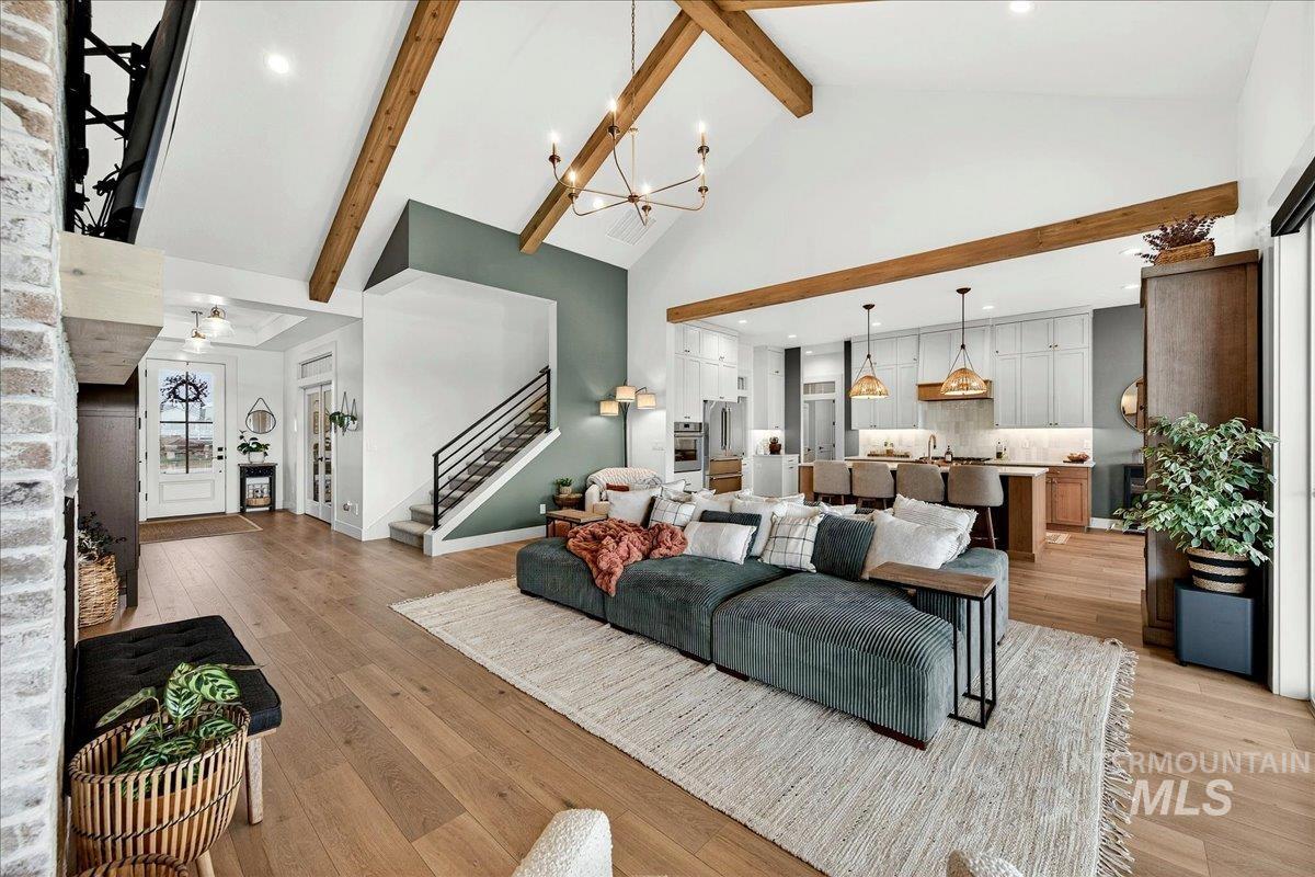 24853 Haflinger Way Middleton, ID 83644 - Photo 13 of 49 Living area featuring hanging lights, light wood-style floors, and lofted ceiling
