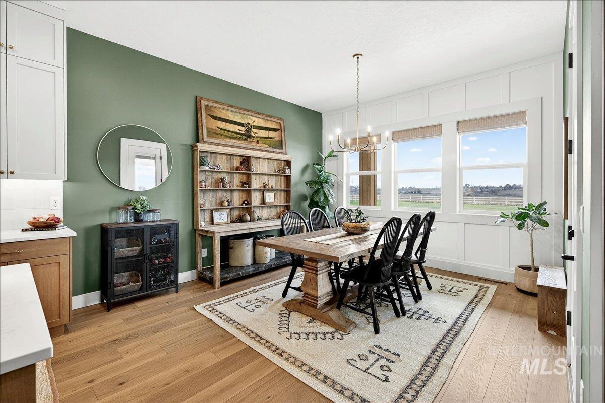 24853 Haflinger Way Middleton, ID 83644 - Photo 21 of 49 Dining area featuring light wood finished floors and a chandelier