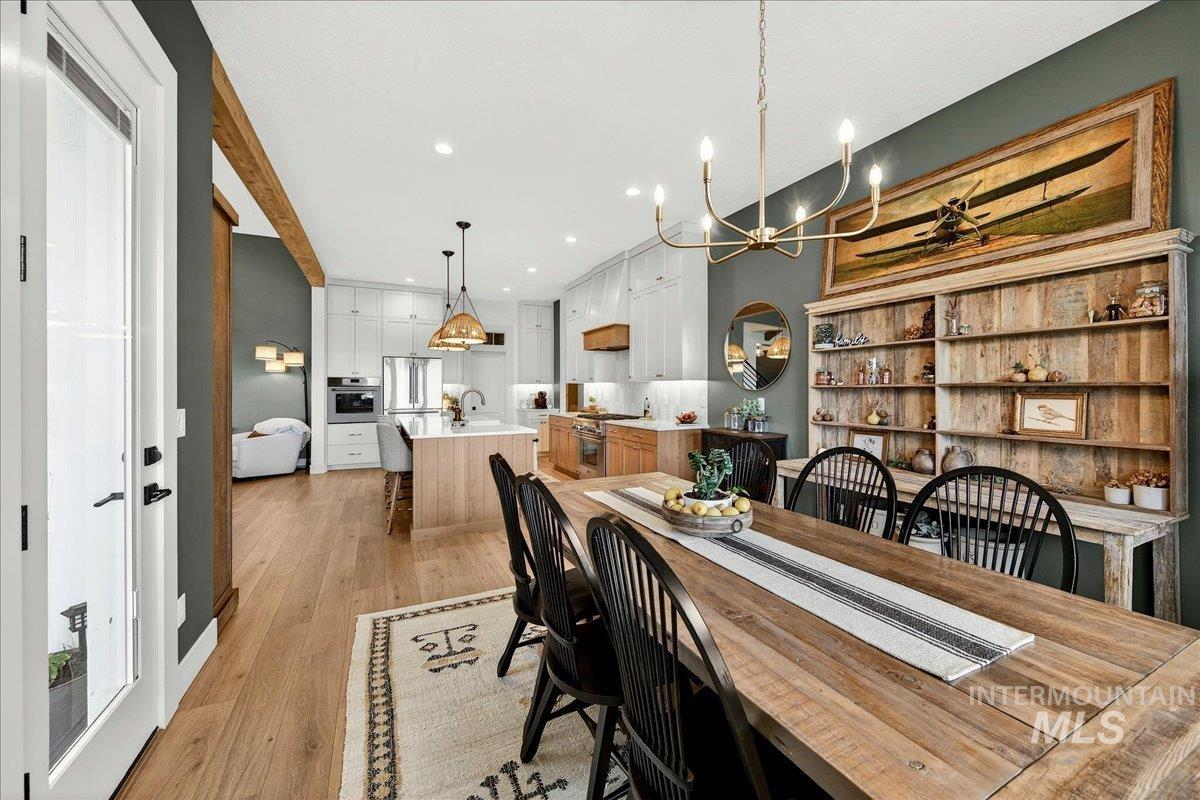24853 Haflinger Way Middleton, ID 83644 - Photo 22 of 49 Dining area with light wood-type flooring and suspended lighting