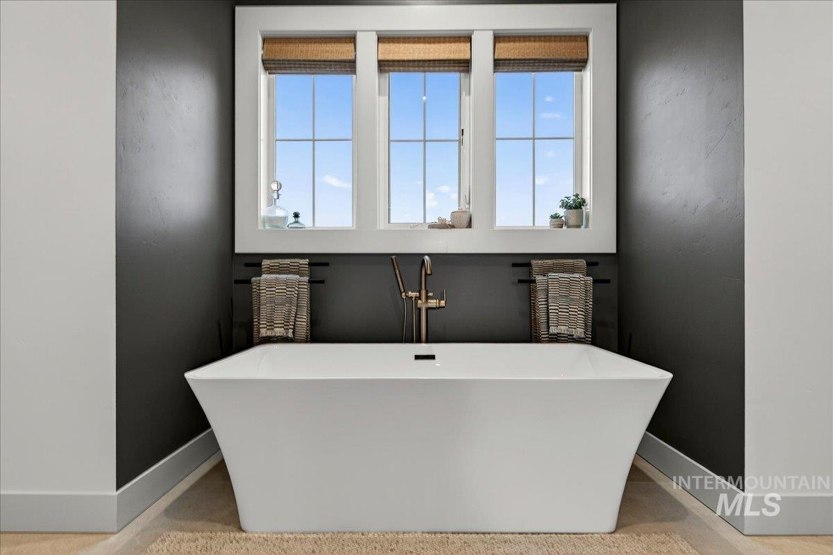 24853 Haflinger Way Middleton, ID 83644 - Photo 26 of 49 Full bathroom with baseboards and a freestanding bath