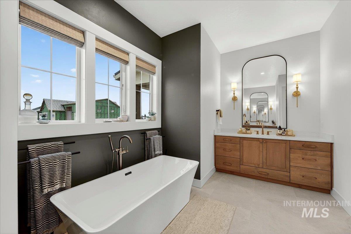 24853 Haflinger Way Middleton, ID 83644 - Photo 27 of 49 Bathroom featuring vanity, a freestanding tub, and light tile patterned flooring