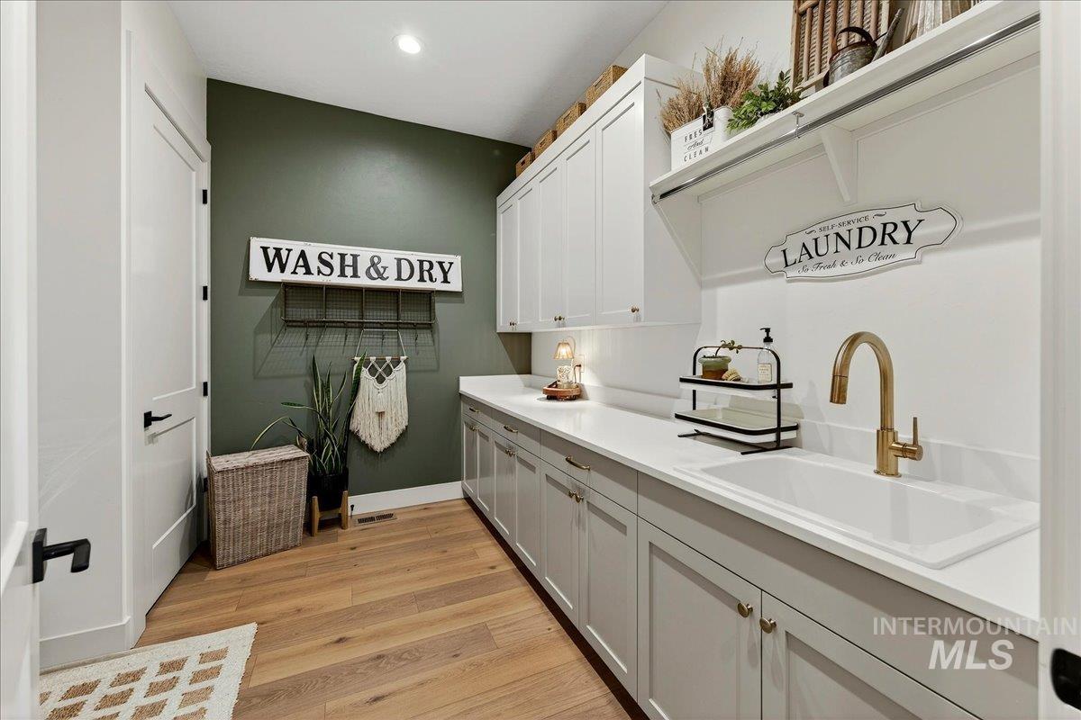 24853 Haflinger Way Middleton, ID 83644 - Photo 36 of 49 Laundry room featuring light wood finished floors and recessed lighting