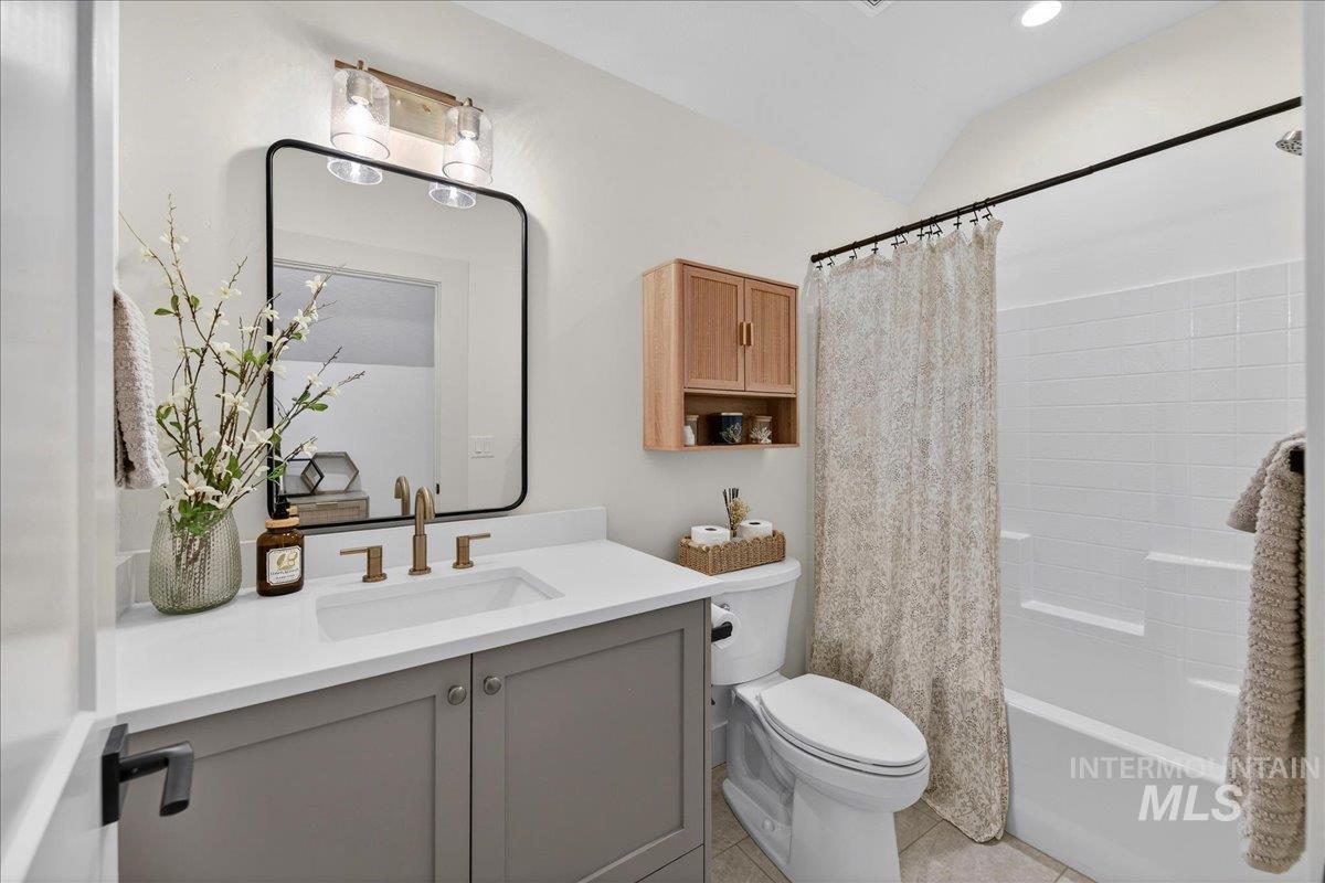 24853 Haflinger Way Middleton, ID 83644 - Photo 41 of 49 Bathroom with vanity, shower / tub combo, lofted ceiling, and light tile patterned floors