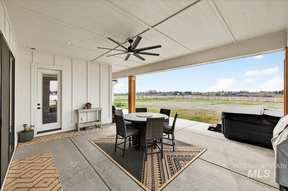 24853 Haflinger Way Middleton, ID 83644 - Photo 42 of 49 View of patio featuring ceiling fan, outdoor dining area, a view of rural / pastoral area, and a hot tub