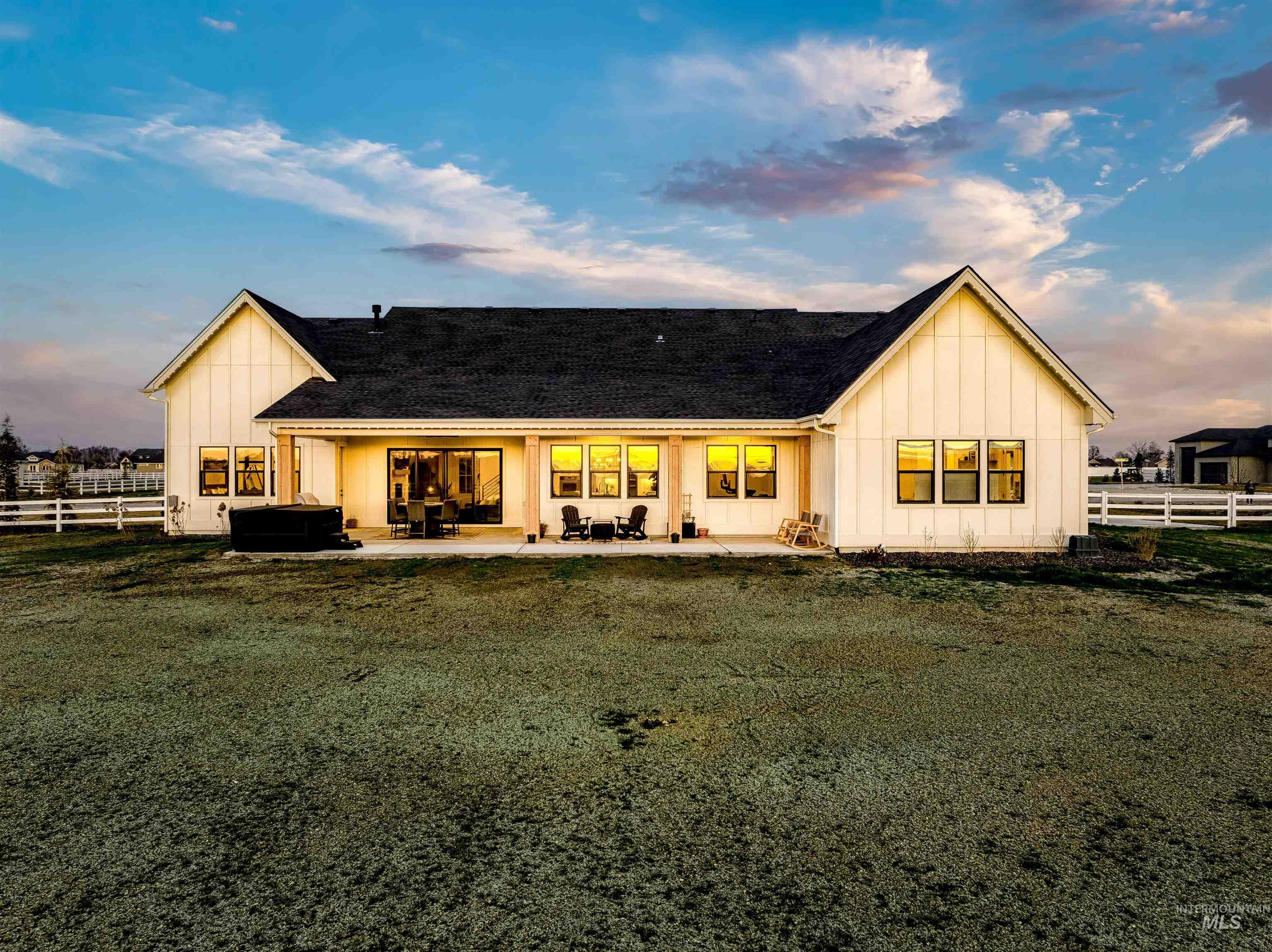 24853 Haflinger Way Middleton, ID 83644 - Photo 43 of 49 Back of property featuring board and batten siding, a patio, a shingled roof, and outdoor furniture