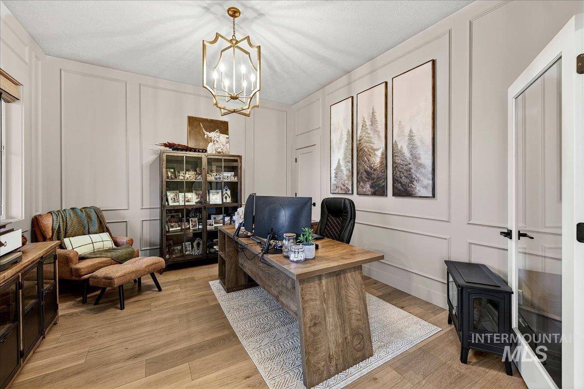 24853 Haflinger Way Middleton, ID 83644 - Photo 8 of 49 Office featuring a decorative wall, light wood-type flooring, and suspended lighting