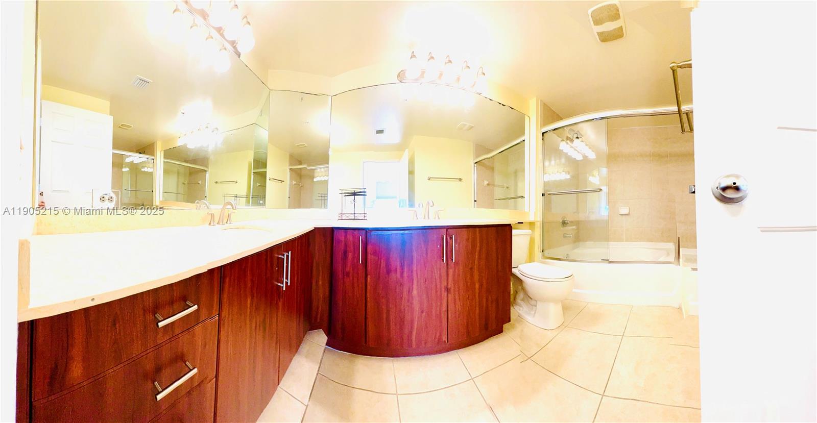 2421 Northeast 65th Street, Unit 506 Fort Lauderdale, FL 33308 - Photo 18 of 59 a bathroom with a mirror and a shower