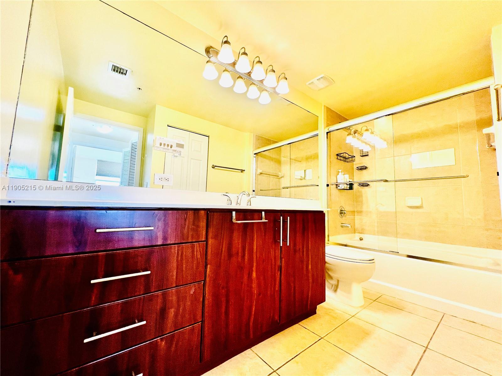 2421 Northeast 65th Street, Unit 506 Fort Lauderdale, FL 33308 - Photo 25 of 59 a bathroom with a mirror and a sink