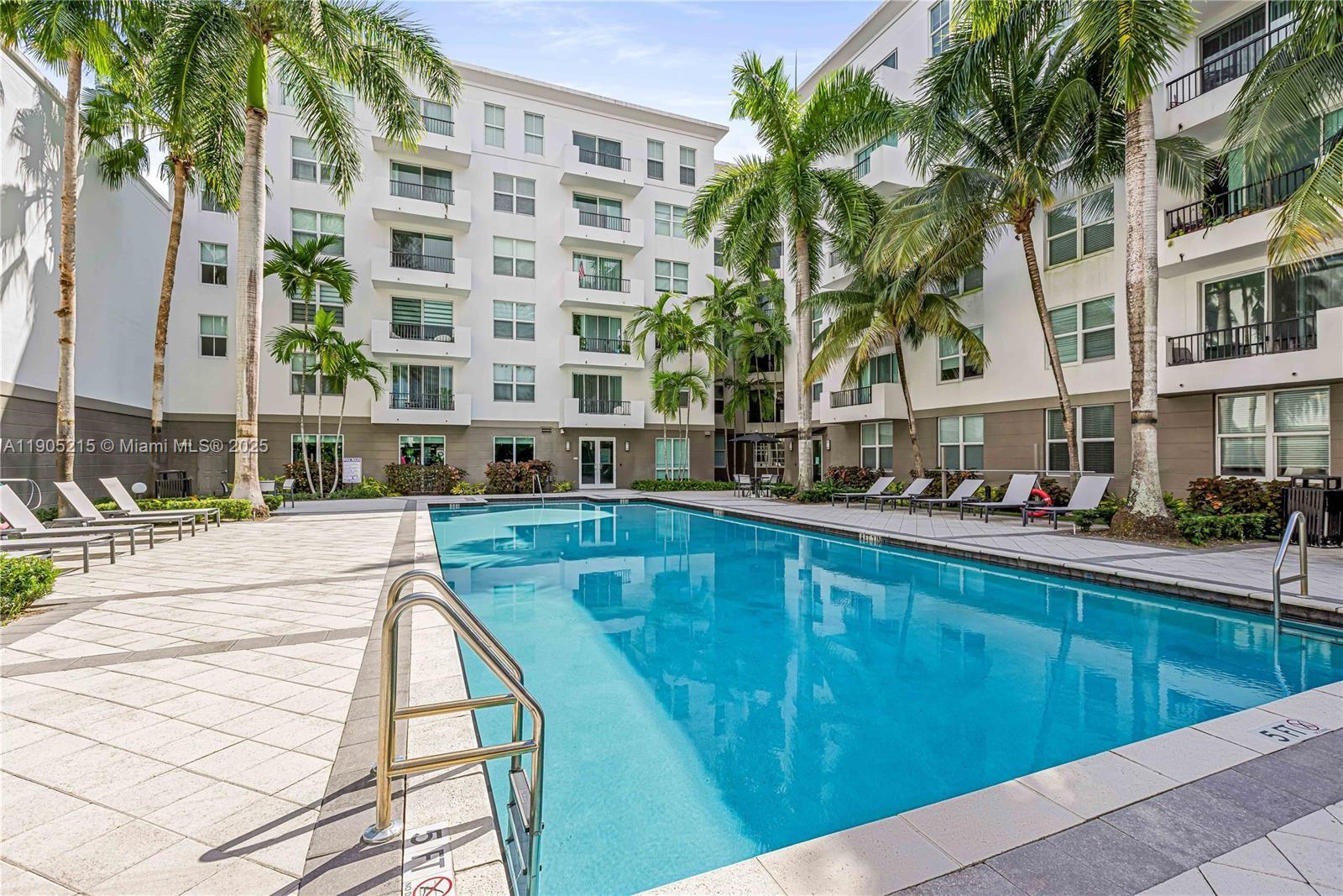 2421 Northeast 65th Street, Unit 506 Fort Lauderdale, FL 33308 - Photo 33 of 59 a swimming pool view with a outdoor seating
