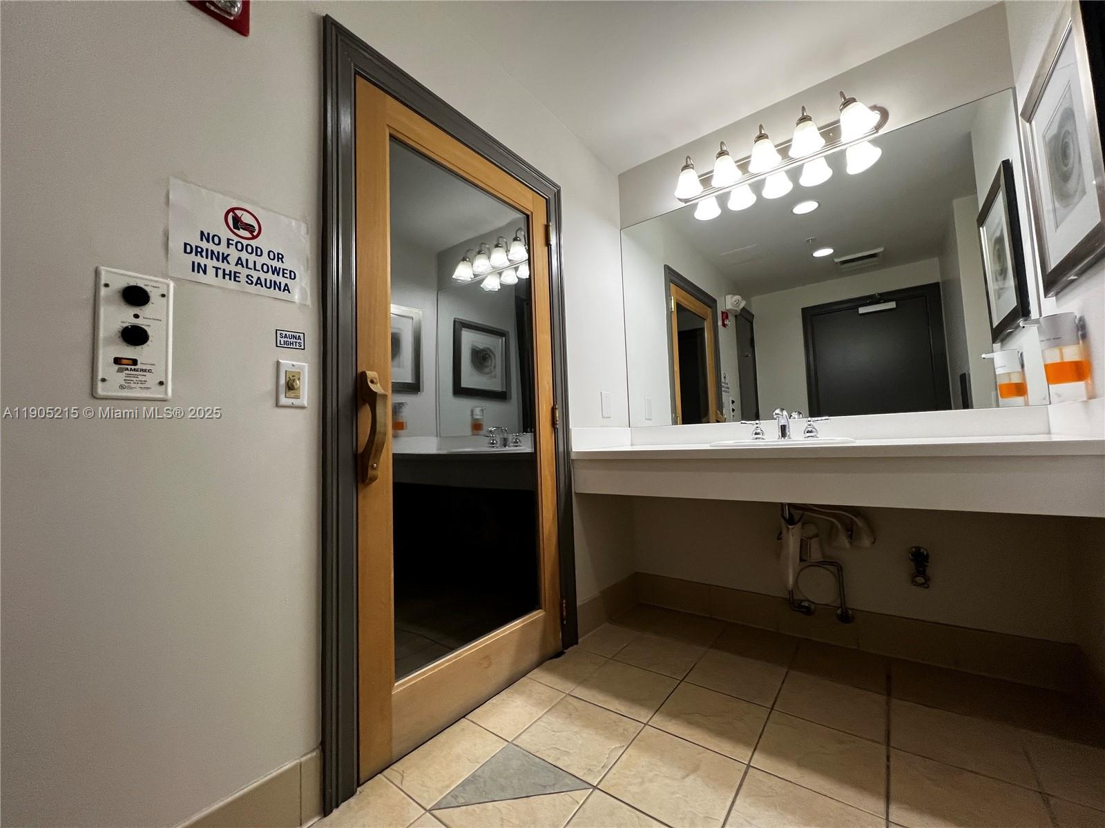 2421 Northeast 65th Street, Unit 506 Fort Lauderdale, FL 33308 - Photo 37 of 59 a bathroom with a sink and a mirror